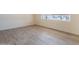 Bright bedroom with fresh floors, base molding, and a large window at 1124 S Longwood Loop, Mesa, AZ 85208