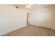 Comfortable bedroom with wood-look floors, closet, and ceiling fan at 1124 S Longwood Loop, Mesa, AZ 85208