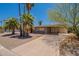 Well-maintained house with desert landscaping, a large driveway, and mature shade trees at 1124 S Longwood Loop, Mesa, AZ 85208
