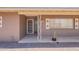 Inviting front porch features desert landscaping, vintage accents, and a sheltered entryway at 1124 S Longwood Loop, Mesa, AZ 85208