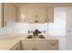 Bright, tiled kitchen area with a vintage range top, ample cabinet storage, and overhead vent at 1124 S Longwood Loop, Mesa, AZ 85208