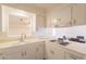 Bright kitchen features tile counters, crisp white cabinetry, and an adjacent dining area at 1124 S Longwood Loop, Mesa, AZ 85208