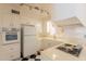Well-lit kitchen featuring tile counters, white appliances, and classic black-and-white flooring at 1124 S Longwood Loop, Mesa, AZ 85208