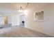 Spacious living room featuring light-colored walls, wood-look floors, and stylish lighting at 1124 S Longwood Loop, Mesa, AZ 85208
