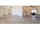 Spacious living room with light-colored floors, access to kitchen and dining area, and lots of light at 1124 S Longwood Loop, Mesa, AZ 85208