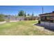 Backyard with green grass, desert plants, block fence and a view of the sun room at 12220 N 22Nd Pl, Phoenix, AZ 85022