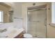 Bathroom featuring a single sink, vanity, and tiled shower with glass doors at 12220 N 22Nd Pl, Phoenix, AZ 85022