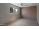 Cozy bedroom with carpet, neutral walls, window, and exposed brick accent wall at 12220 N 22Nd Pl, Phoenix, AZ 85022