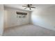 Comfortable bedroom with neutral walls, carpet, ceiling fan, and large window at 12220 N 22Nd Pl, Phoenix, AZ 85022