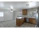Bright eat-in kitchen with tile flooring, oak cabinets, and stainless steel appliances at 12220 N 22Nd Pl, Phoenix, AZ 85022