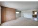 Open-concept living room with brick accent wall and view into adjacent kitchen at 12220 N 22Nd Pl, Phoenix, AZ 85022