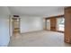 Bright living room with a large window, neutral carpet, and brick accents at 12220 N 22Nd Pl, Phoenix, AZ 85022