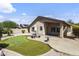 Spacious backyard featuring a putting green, covered patio, and lush desert landscaping at 12732 S 175Th Dr, Goodyear, AZ 85338