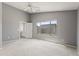 Spacious bedroom with neutral gray walls, carpet floors, ceiling fan, and a window offering natural light at 12732 S 175Th Dr, Goodyear, AZ 85338