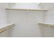 A walk-in closet with built in shelving and wooden clothes rods at 12732 S 175Th Dr, Goodyear, AZ 85338