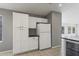 Bright kitchen features white cabinets, tile flooring, and a large refrigerator at 12732 S 175Th Dr, Goodyear, AZ 85338