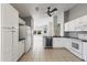 Open concept kitchen with sleek black countertops, white cabinets, and stainless steel appliances at 12732 S 175Th Dr, Goodyear, AZ 85338