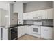 Updated kitchen with white cabinets, black countertops and stainless steel appliances at 12732 S 175Th Dr, Goodyear, AZ 85338