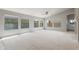 Bright living room with large windows, vaulted ceiling, ceiling fan, and neutral flooring at 12732 S 175Th Dr, Goodyear, AZ 85338