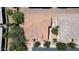 An aerial view showcases a well-maintained home with a red tiled roof surrounded by mature trees at 14870 W Encanto Blvd # 1038, Goodyear, AZ 85395
