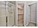 Bathroom with glass-enclosed shower and walk-in closet at 14870 W Encanto Blvd # 1038, Goodyear, AZ 85395