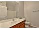 This bathroom features a large mirror and a single sink vanity with wood cabinets at 14870 W Encanto Blvd # 1038, Goodyear, AZ 85395