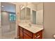 This bathroom features a sink and vanity with wood cabinets at 14870 W Encanto Blvd # 1038, Goodyear, AZ 85395