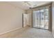 Neutral bedroom with carpet and sliding glass doors at 14870 W Encanto Blvd # 1038, Goodyear, AZ 85395