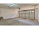 This garage has a large automatic garage door with a cement floor at 14870 W Encanto Blvd # 1038, Goodyear, AZ 85395