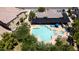 Aerial view of a beautiful community pool featuring a spa, shaded seating, and lush landscaping at 14870 W Encanto Blvd # 1038, Goodyear, AZ 85395