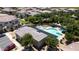 An aerial view highlights the inviting community pool with relaxing lounge chairs and lush landscaping at 14870 W Encanto Blvd # 1038, Goodyear, AZ 85395