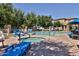 This pool and spa is surrounded by mature trees and lounge chairs at 14870 W Encanto Blvd # 1038, Goodyear, AZ 85395