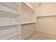 Spacious walk-in closet features wood shelving at 14870 W Encanto Blvd # 1038, Goodyear, AZ 85395