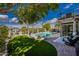 Lush backyard with a refreshing pool, mature trees, and a covered patio with seating at 15411 S 13Th Ave, Phoenix, AZ 85045