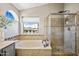 Beautiful bathroom with a large tub, a separate shower, and a window with a view at 15411 S 13Th Ave, Phoenix, AZ 85045