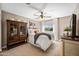 Bright bedroom with a ceiling fan, soft carpet, and a picturesque window view at 15411 S 13Th Ave, Phoenix, AZ 85045