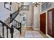 Grand foyer showcasing high ceilings, staircase with black railing and beautiful front door at 15411 S 13Th Ave, Phoenix, AZ 85045