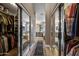 Hallway with dual closets leading to a bathroom, showcasing tile flooring and neutral paint throughout at 15411 S 13Th Ave, Phoenix, AZ 85045