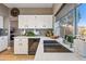 Bright kitchen with white cabinets, stainless steel sink, and a large window at 15411 S 13Th Ave, Phoenix, AZ 85045
