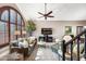 Spacious living room with a ceiling fan, plush seating, and expansive windows at 15411 S 13Th Ave, Phoenix, AZ 85045