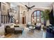 Bright and airy living room with high ceilings, comfortable seating, and arched windows at 15411 S 13Th Ave, Phoenix, AZ 85045