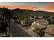 Charming street view featuring well-maintained homes and desert landscaping against a backdrop of scenic mountains at 15411 S 13Th Ave, Phoenix, AZ 85045