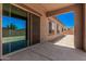 Covered back patio with sliding glass doors leading to the interior of the house at 17308 W Royal Palm Rd, Waddell, AZ 85355