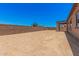 Expansive backyard with potential for landscaping and outdoor activities, enclosed by a privacy wall at 17308 W Royal Palm Rd, Waddell, AZ 85355