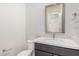Bathroom features a toilet, sink and vanity with a gray cabinet and white countertop at 17308 W Royal Palm Rd, Waddell, AZ 85355