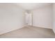 Spacious bedroom featuring carpet flooring and an entrance to another room at 17308 W Royal Palm Rd, Waddell, AZ 85355