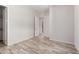 A light and airy bedroom shows modern design and access to a closet and hallway at 17308 W Royal Palm Rd, Waddell, AZ 85355