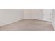 Bedroom showcasing neutral carpet and a white door leading to the hallway at 17308 W Royal Palm Rd, Waddell, AZ 85355