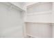 Walk-in closet showcasing built-in shelving and rod storage for optimal organization at 17308 W Royal Palm Rd, Waddell, AZ 85355