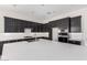 Modern kitchen with dark cabinets, stainless steel appliances, a large island, and white subway tile backsplash at 17308 W Royal Palm Rd, Waddell, AZ 85355